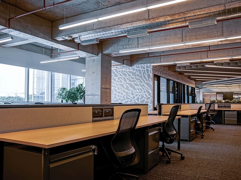 empty office featuring numerous desks and chairs