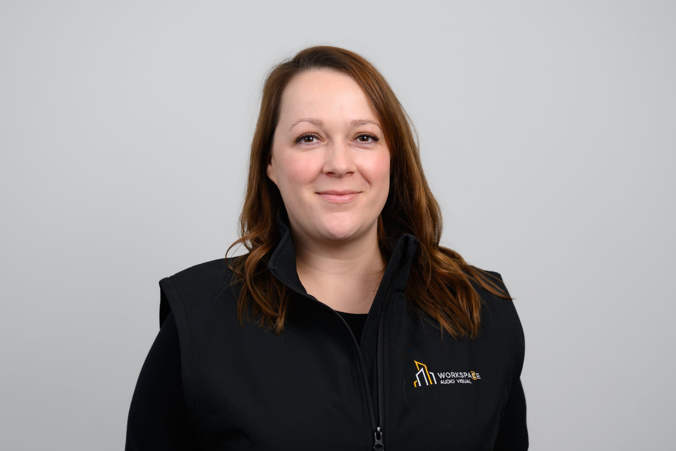 woman wearing a black jacket and smiling