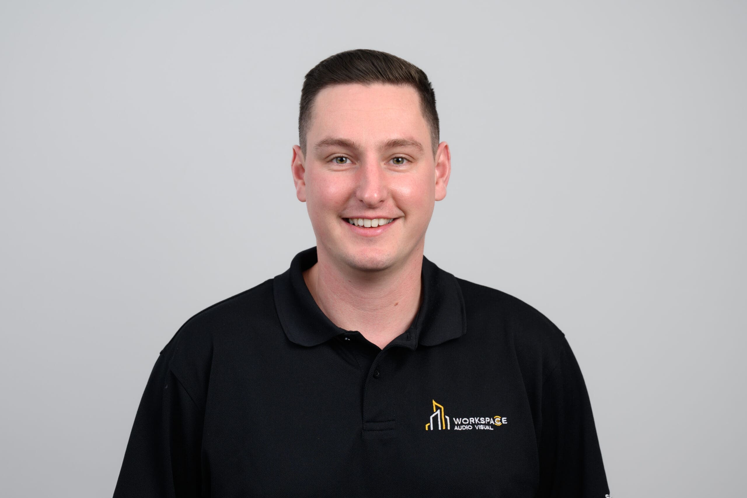 man in a black shirt is smiling