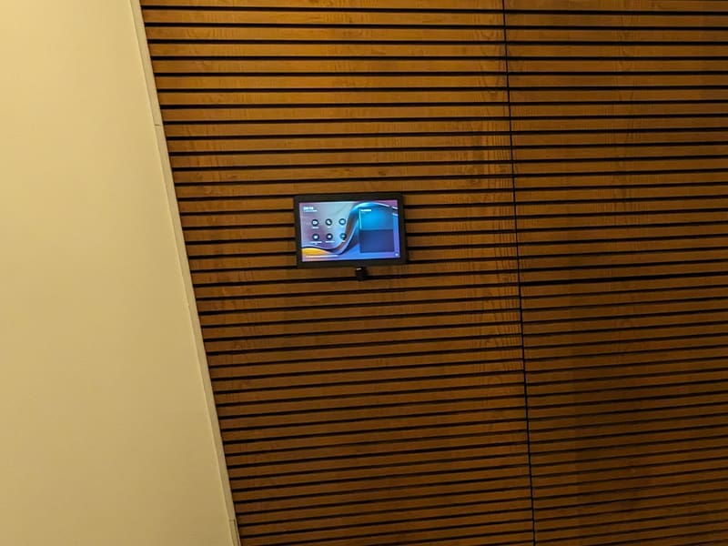 television is mounted on a wooden wall