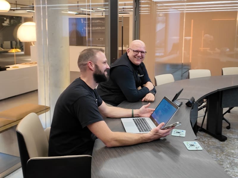 wo men sitting at a table with a laptop