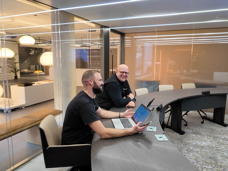 wo men sitting at a table with a laptop