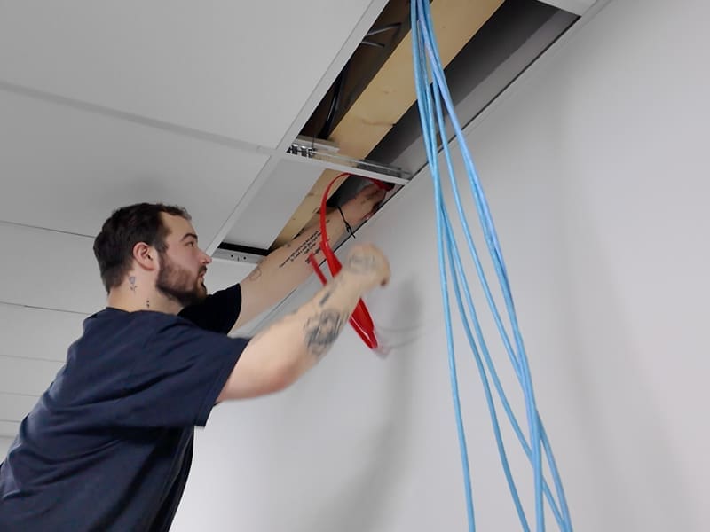man working on a ceiling in a room