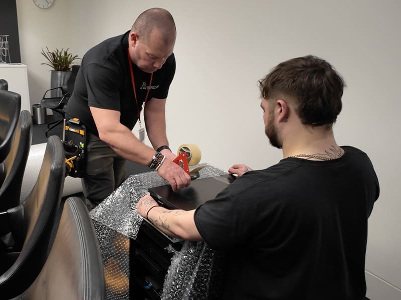man getting a haircut from another man