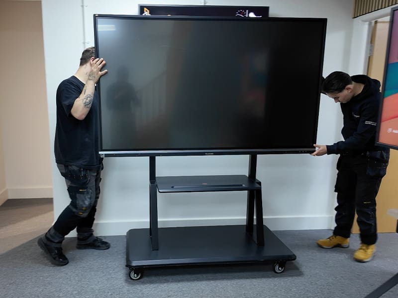 wo men standing in front of a flat screen tv