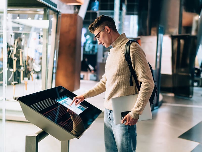 man standing in front of a display of electronic devices