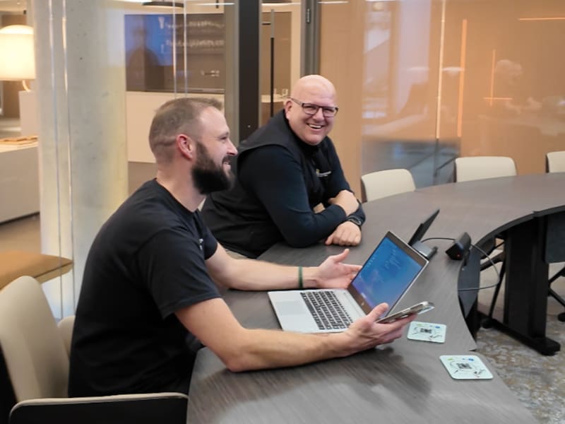 wo men sitting at a table with a laptop