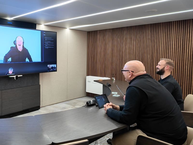 group of men sitting around a conference room table