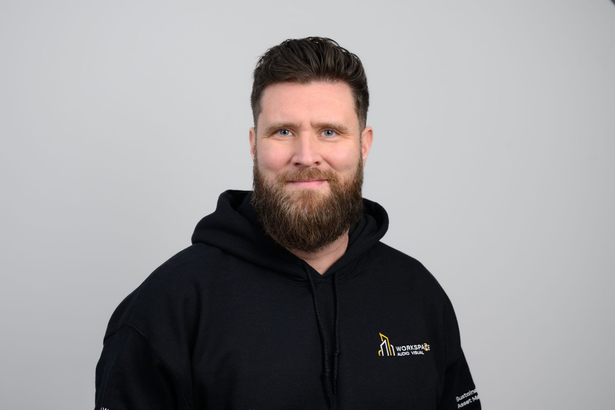 man with a beard wearing a black hoodie