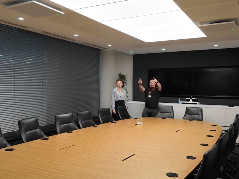 wo people standing in front of a conference table