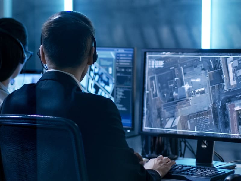 couple of people sitting in front of a computer