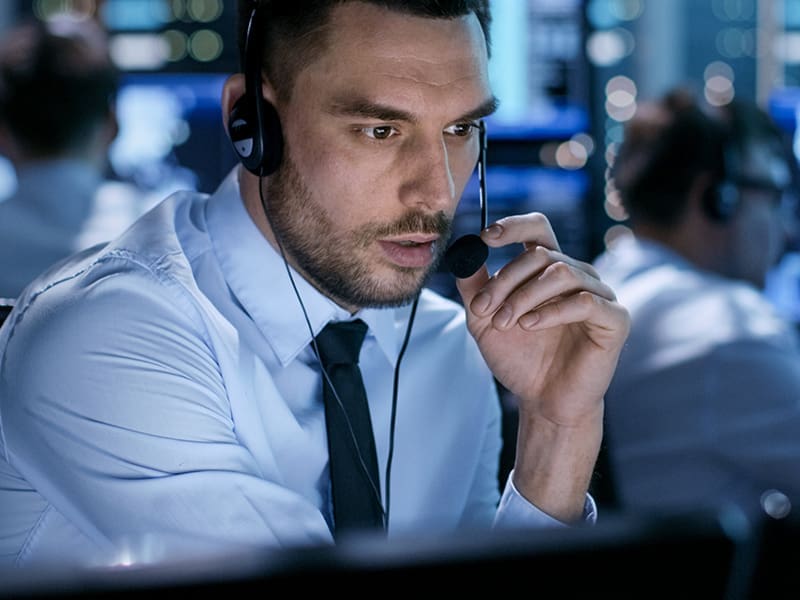 man in a white shirt and tie wearing headphones