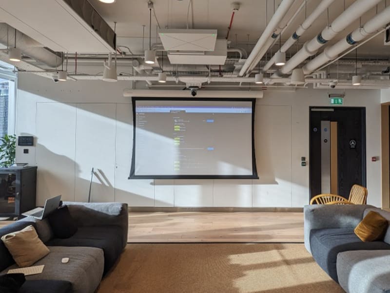 large room with couches and a projector screen