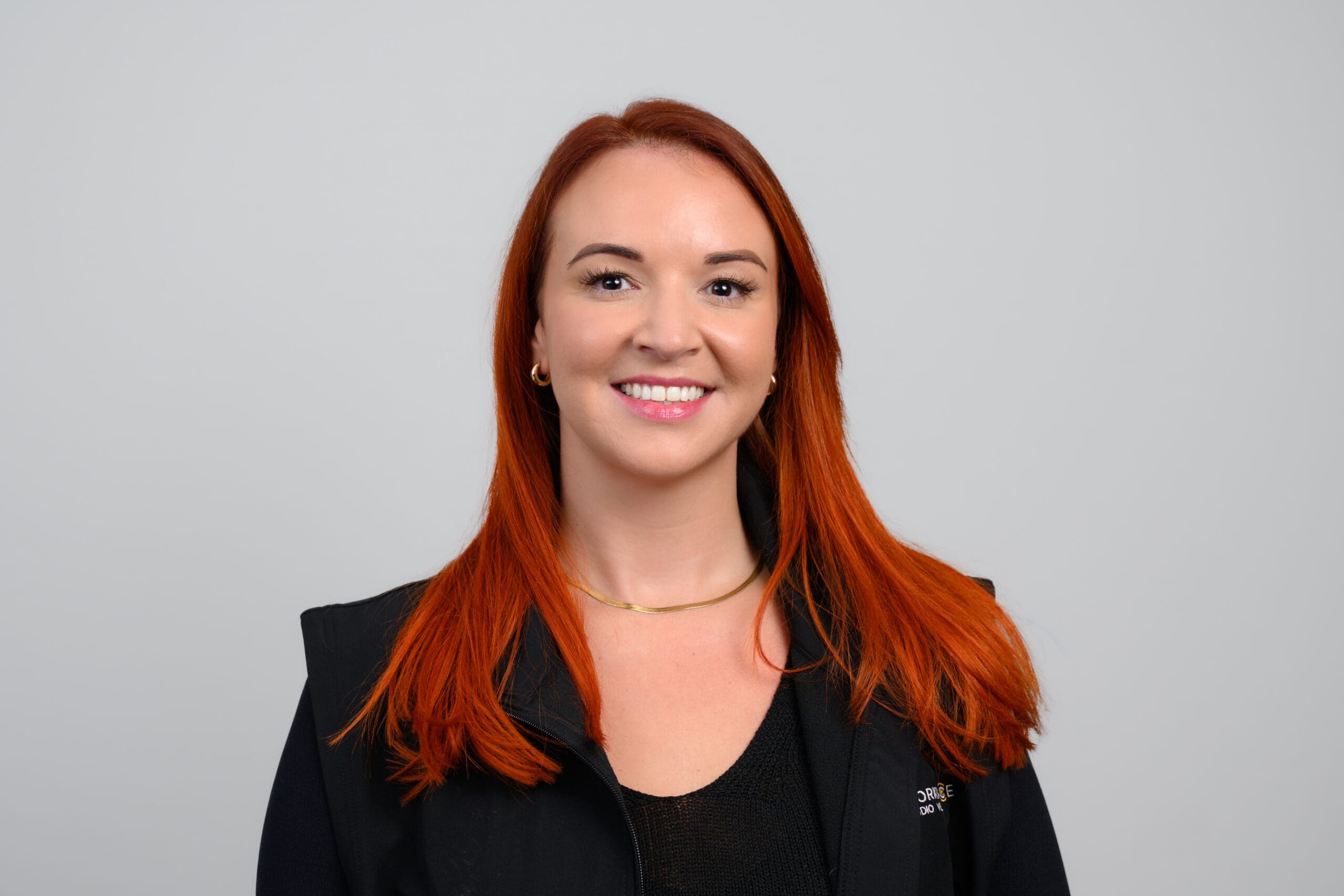 woman with red hair and a black jacket