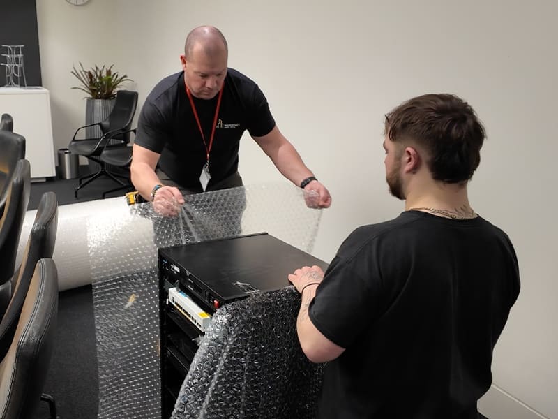man standing next to another man in a room