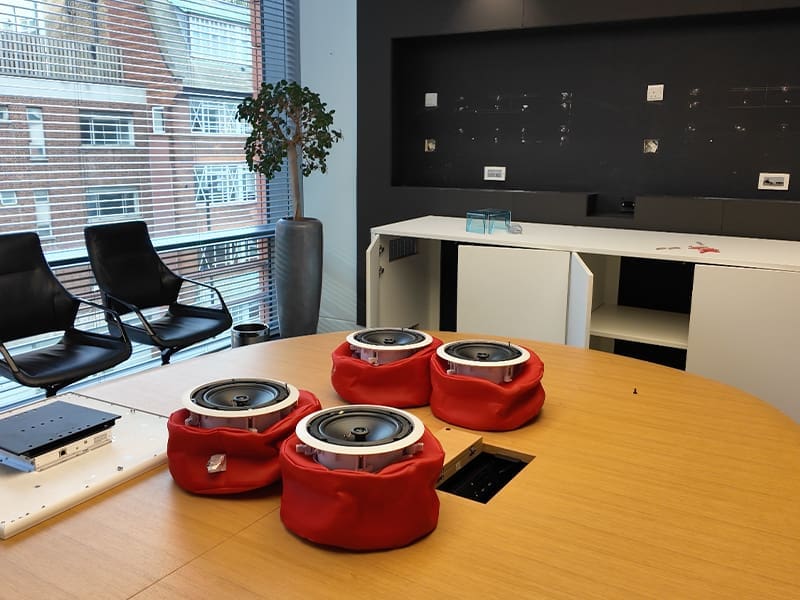 conference room with chairs and a table with speakers on it