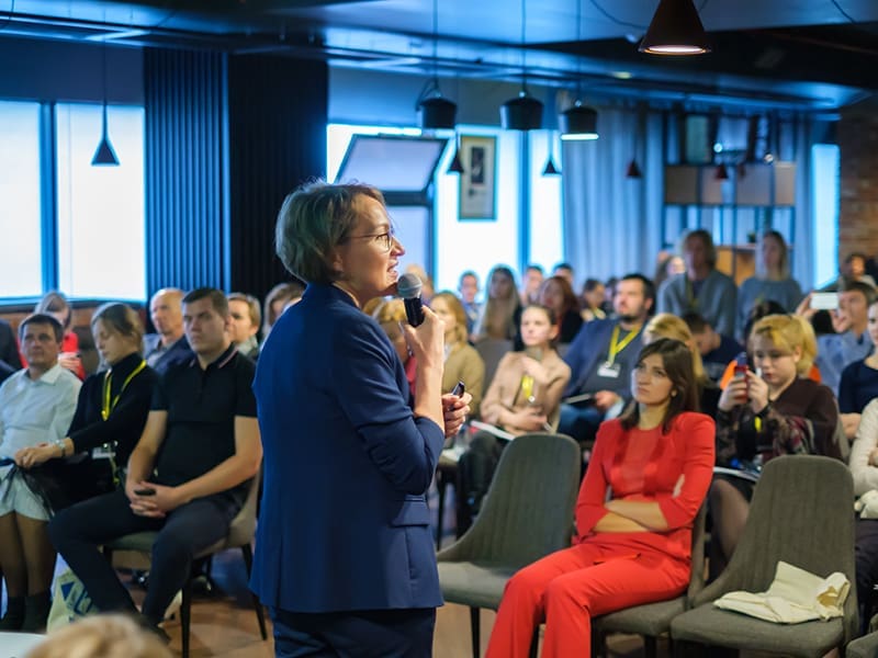 man standing in front of a crowd of people