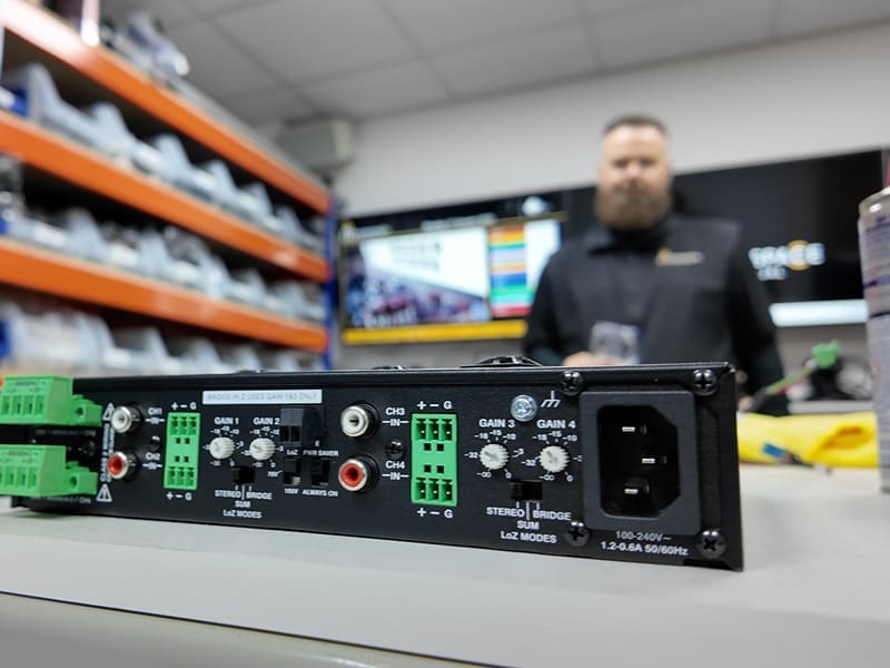 man is standing behind a control panel in a store