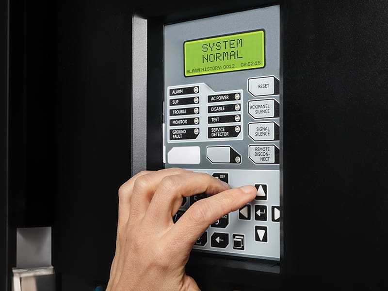 person pressing a button on a machine