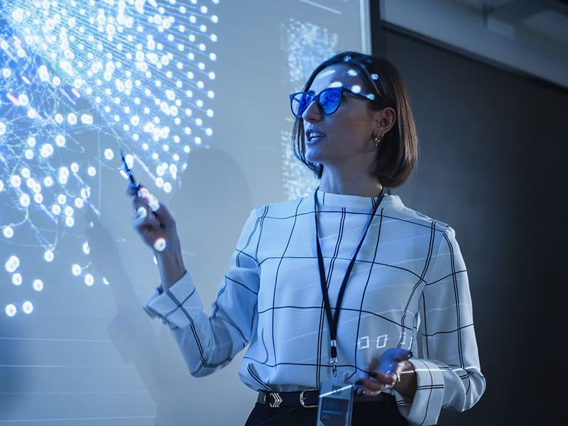 woman standing in front of a projection screen