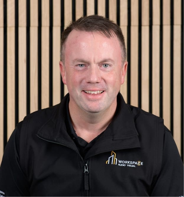 man in a black shirt is smiling