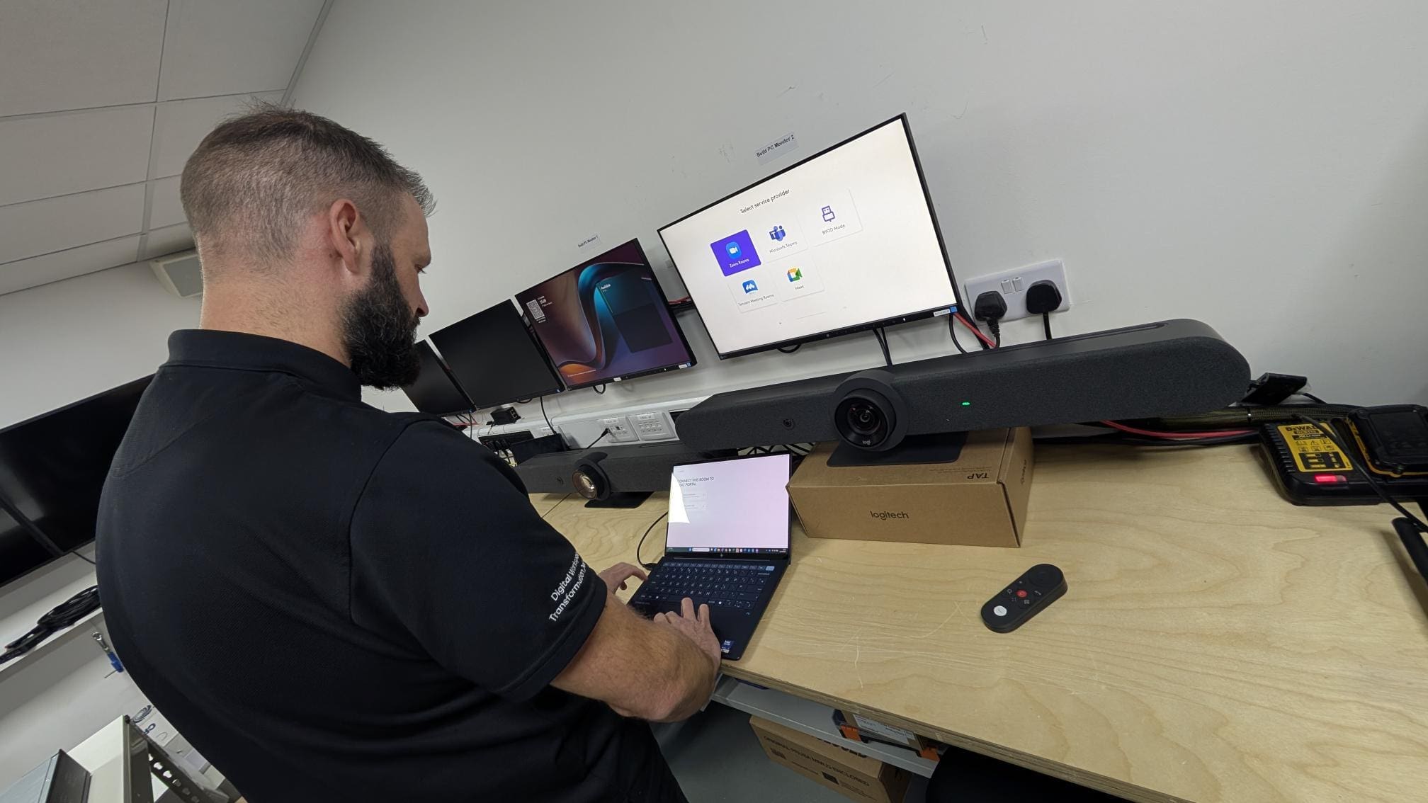 man sitting at a desk working on a laptop